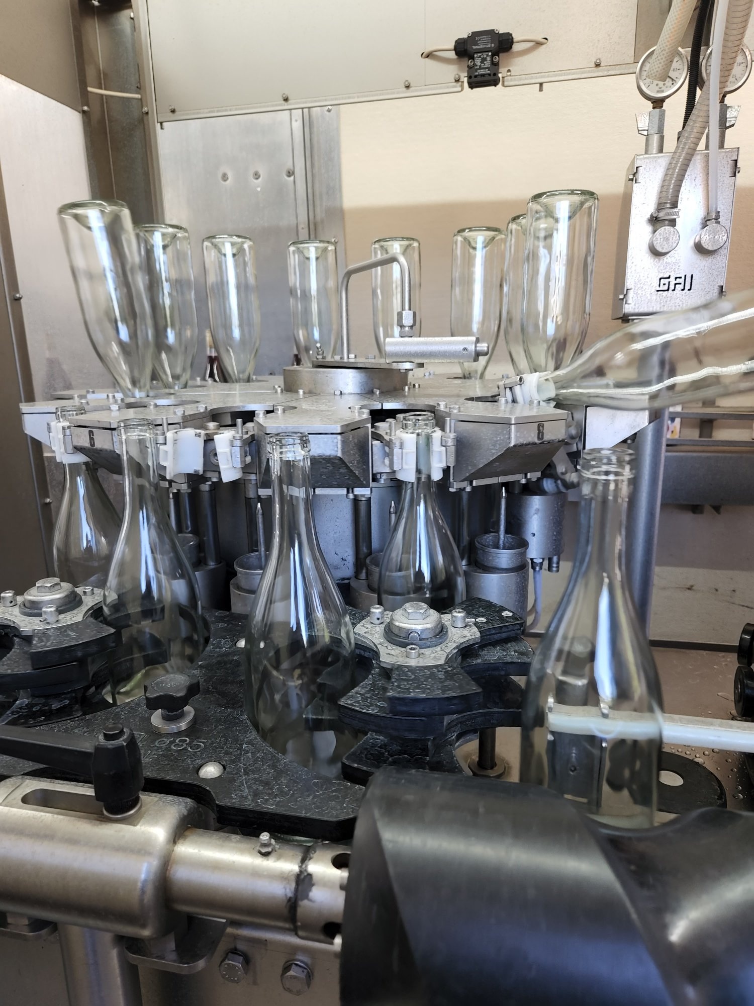 GAI rotary bottle filler with precision filling heads at Bin to Bottle